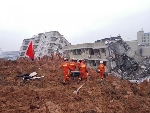 Firefighters search for survivors among the rubble of collapsed buildings after a landslide hit an industrial park in Shenzhen, Guangdong province, China December 21, 2015. ReutersStringer