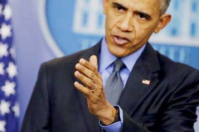 U.S. President Barack Obama gestures as he holds his end of the year news conference at the White House in Washington.