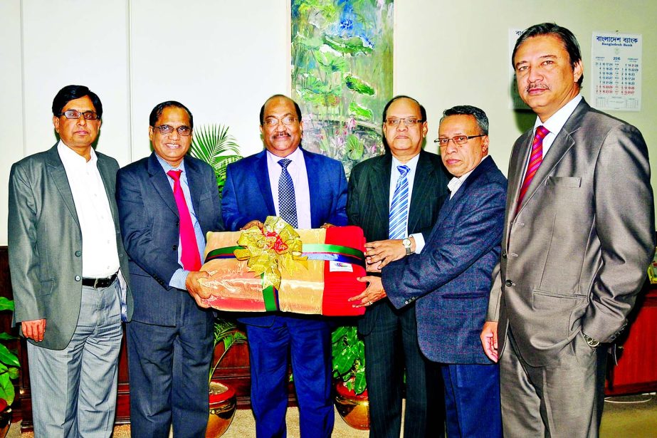 KS Tabrez, Managing Director of Dutch-Bangla Bank handing over a sample of the blankets of 10,000 for cold hit people to SK Sur Chowdhury, Deputy Governor of Bangladesh Bank at BB head office on Sunday.