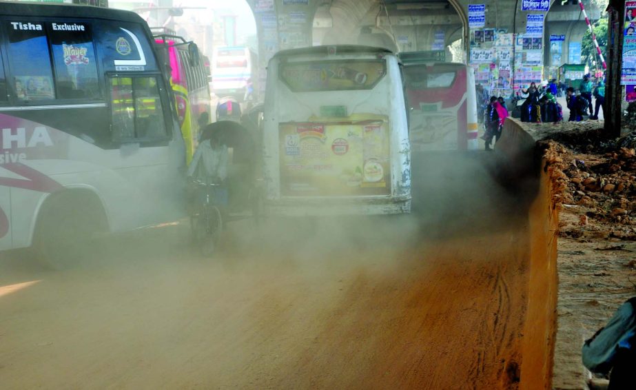 The sight around the city's Hanif Flyover being obscured even in daylight due to dusty. But the authority concerned seemed to be blind to remove the heap of soil brought for constructing the flyover to mitigate the woes of the road users. The snap was ta