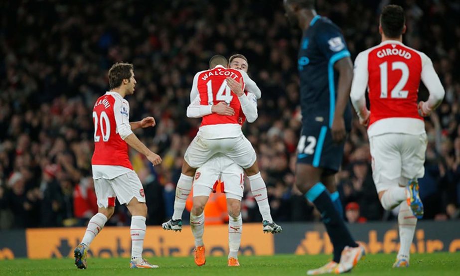 Walcott of Arsenal celebrates after scoring the opening goal against Man City during the Premier League match between Arsenal and Man City at the Emirates Stadium on Monday.