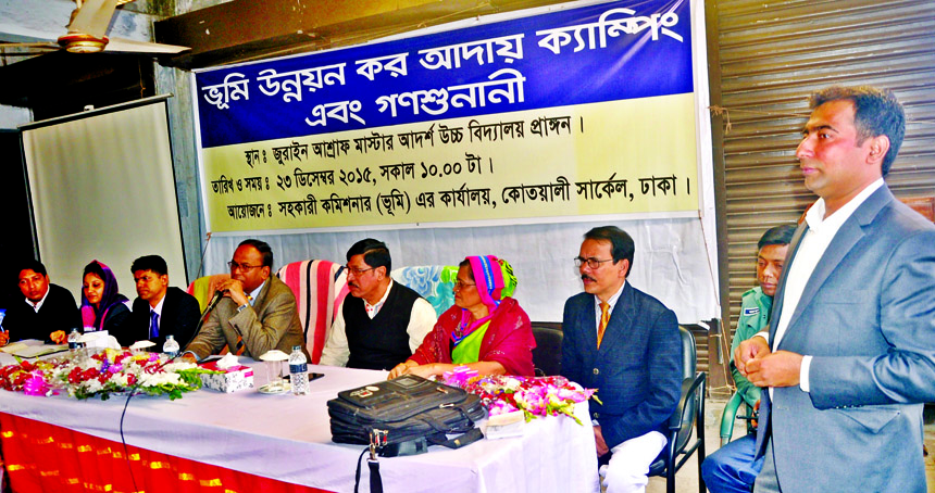 Deputy Commissioner of Dhaka district Tofazzal Hossain Miah speaking at a programme on Land Development Tax Realisation Camping and Mass Hearing organized by Assistant Commissioner (Land) Office, Kotwali Circle at Ashraf Master Adarsha High School in the
