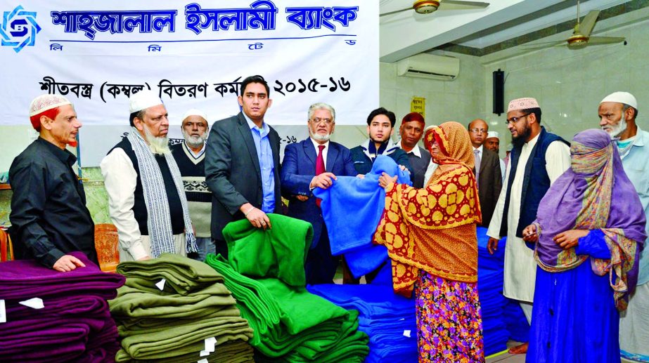 Alhaj Mohiuddin Ahmed Director of Shahjalal Islami Bank Ltd. and Chairman of Shahjalal Islami Bank Securities Ltd. distributing blankets among winter hit and poor people at city's Bangshal area recently.