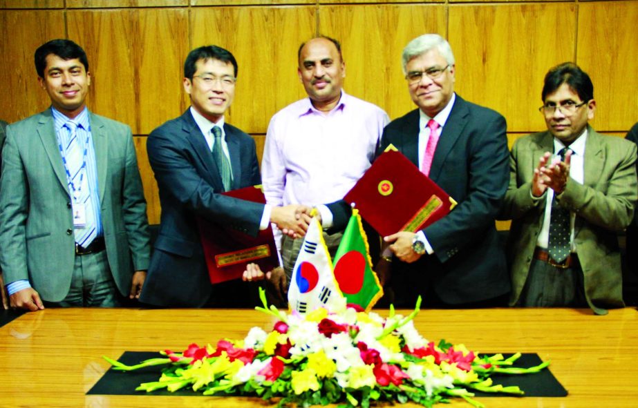 Kim Jihoon, Country Director of KOICA Bangladesh Office and Mohammad Asif-uz-Zaman, Additional Secretary of ERD exchanging agreement documents at the conference room of ERD in the city on Sunday.