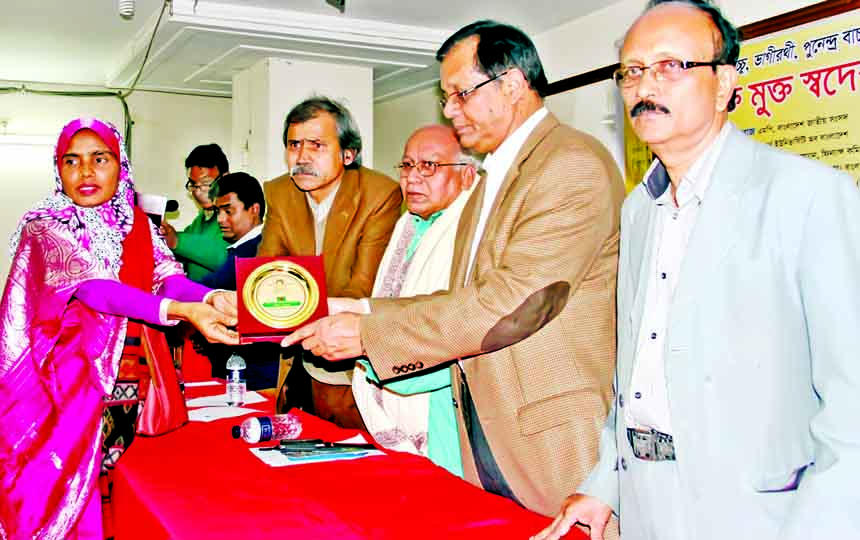 Chief Whip ASM Feroj giving away certificate to Dr Shakila Khanam for her contributions in homoeo treatment and social work at a ceremony organized by Shaheed Bidhan Smrity Parishad at Muktibhaban in the city on Sunday.