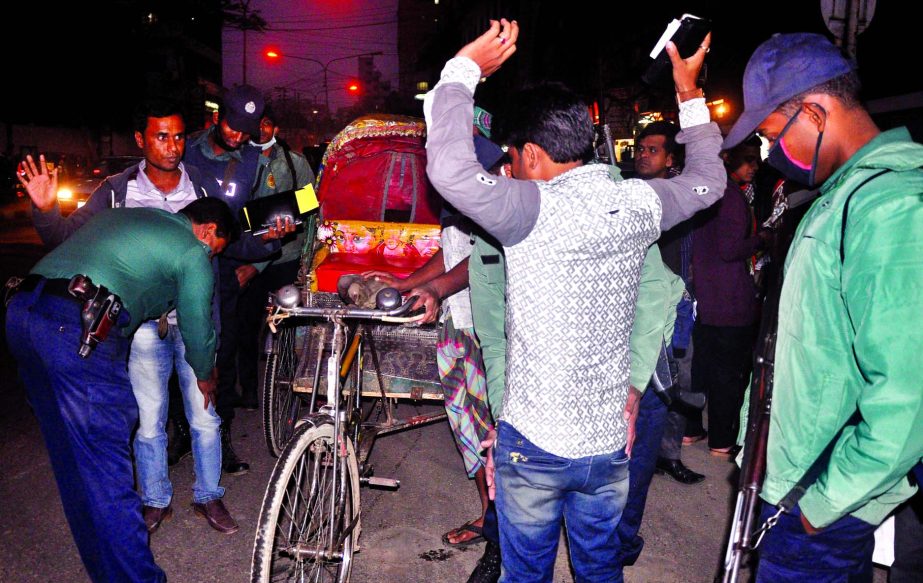 Foolproof security measures were taken in city ahead of 31st night on Thursday. Photo shows law enforcers searching pedestrians at R.K. Mission Road near Motijheel, Dhaka on Tuesday.