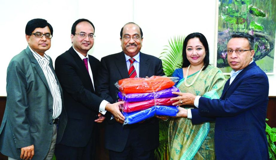 Imtiaz Ibne Sattar, Acting CEO of Standard Chartered Bangladesh and Bitopi Das Chowdhury, Country Head of Corporate Affairs of Standard Chartered Bangladesh, handing over the blankets for distribution amongst the poor to SK Sur Chowdhury, Deputy Governor