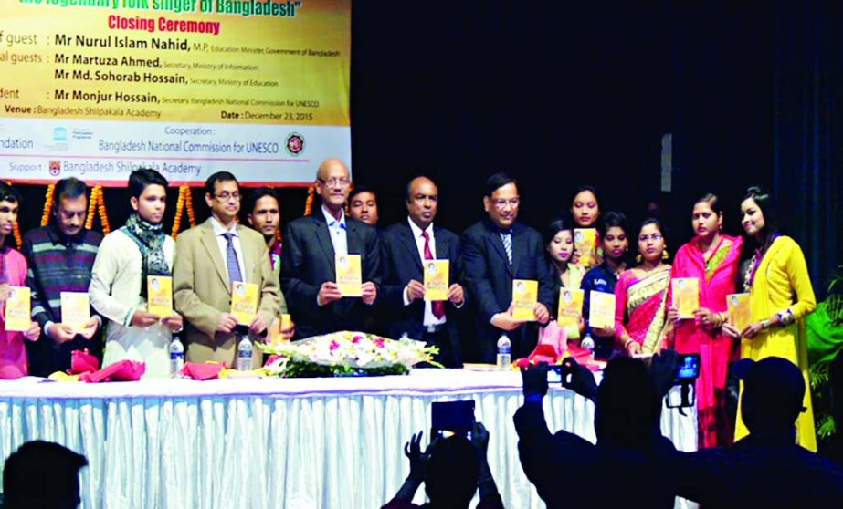 Education Minister Nurul Islam Nahid along with others holds the copies of a book written by researchers on singer Abdul Alim and DVD of different singers at its cover unwrapping ceremony in UNESCO participation programme 2014-'15 organized recently by A