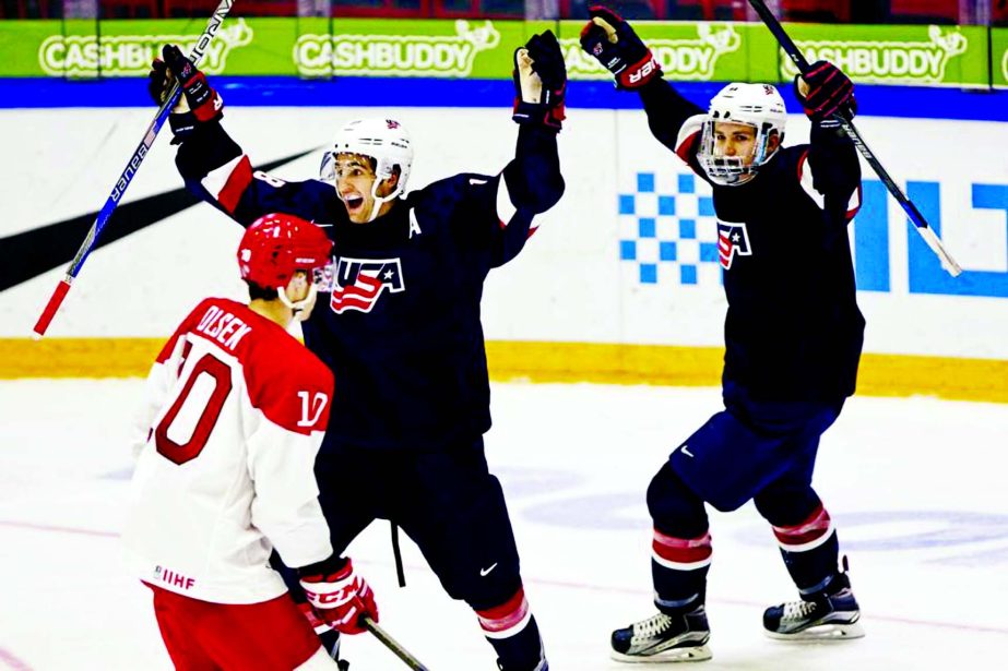 Goal scorer Colin White of the US (center) and teammate Matthew Tkachuk celebrate in front of Denmark's Thomas Olsen during the 2016 IIHF World Junior U20 Ice Hockey Championships tournament match between Denmark and USA in Helsinki, Finland on Thursday