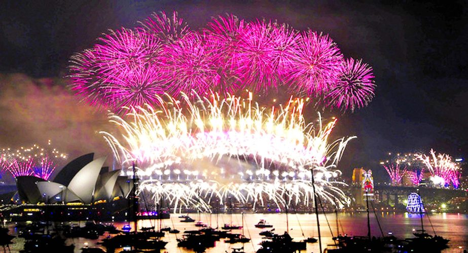 Fireworks light the sky above the medieval Mariendom or St. Mary's Cathedral, (right), and St. Severi's Church shortly after midnight during the New Year celebrations in Erfurt, central Germany.