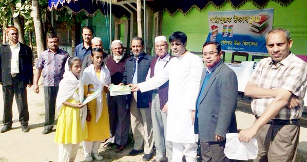 Alhaj Abu Ahmed, President, Burishar High School distributing new books among the students yesterday.