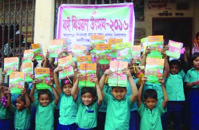 JHENIDAH: Students of Arpara Shibpur Model Govt Primary School in Kaliganj Upazila showing their text books at the books distributing ceremony in school premises on Friday.