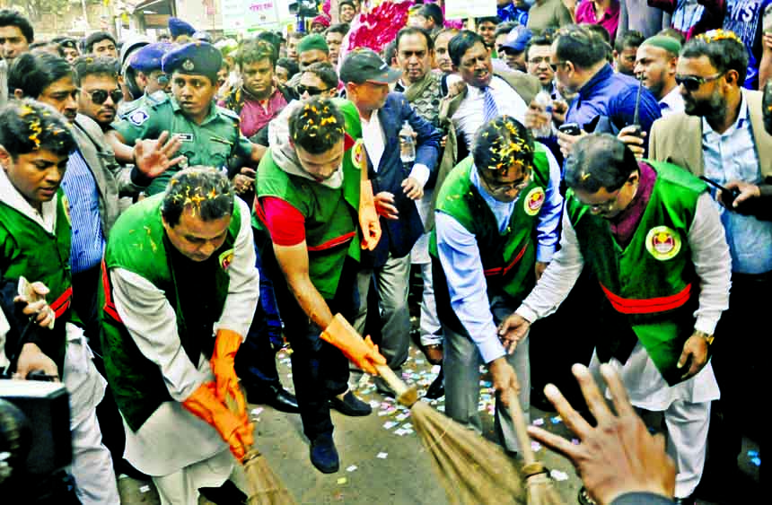 Planning Minister AHM Mostafa Kamal and DSCC Mayor Mohammad Sayeed Khokon, among others, in the cleaning drive at Victoria Park area in the city on Saturday with a view to making livable Dhaka.