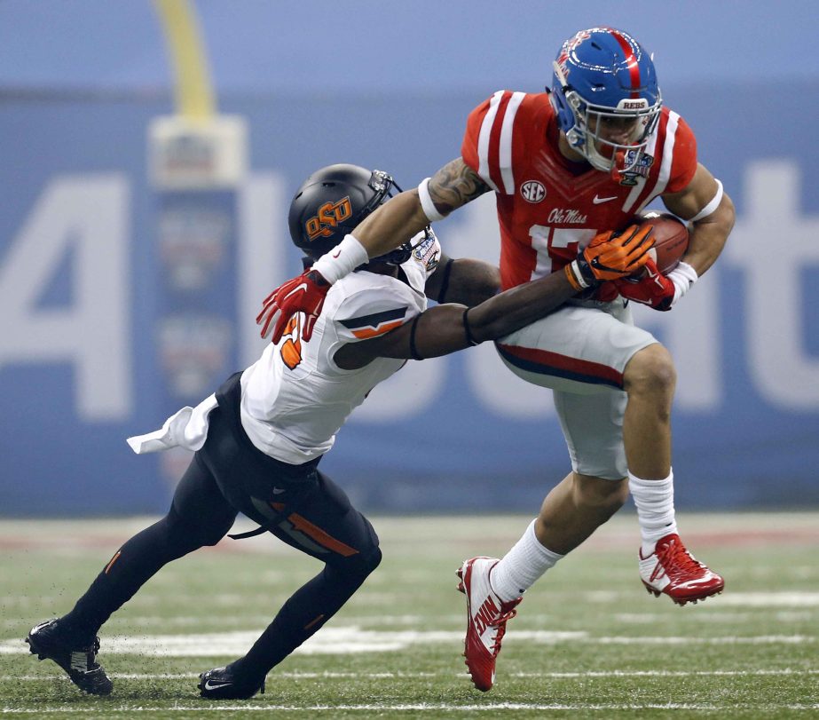 Mississippi tight end Evan Engram (17) carries as Oklahoma State safety Tre Flowers (31) tries to tackle in the first half of the Sugar Bowl college football game in New Orleans on Friday.