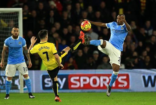 Watford's Jose Manuel Jurado and Manchester City's Fernandinho (right) battle for the ball during the English Premier League soccer match at Vicarage Road in London on Saturday.