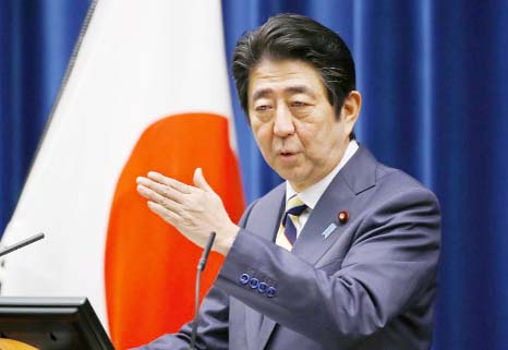 Japanese Prime Minister Shinzo Abe speaks to the media during the New Year's press conference at his official residence in Tokyo on Monday.