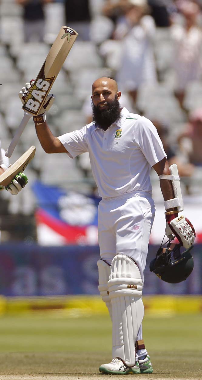South African Hashim Amla lifts his bat in the air after making more than a hundred runs during their second cricket Test against England in Cape Town, South Africa on Monday.