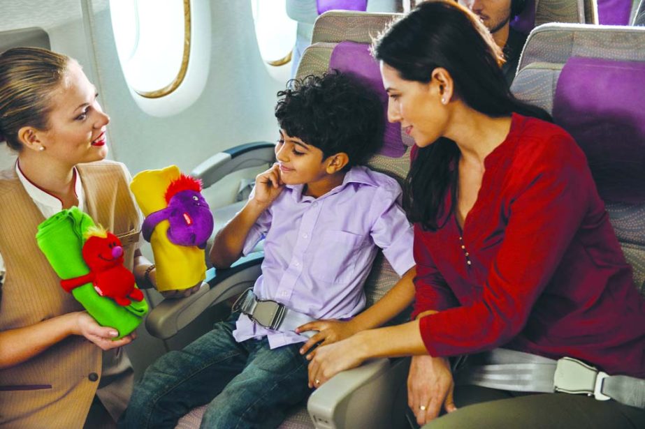 Travellers including women and children witness in a cheerful mood in Emirates Flight