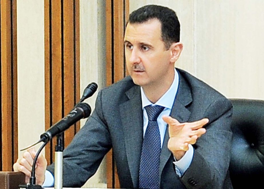 AP file photo shows Syrian President Bashar al-Assad talking to newsmen in Baghdad.