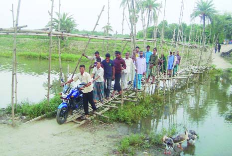 JHENIDAH: A pucca bridge is urgently needed immediately over Fatki River in Natopara Village in Kaliganj Upazila. This picture was taken on Wednesday..