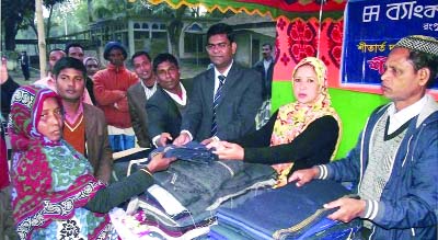 RANGPUR: Nazmun Nahar Nazma , Councilor distributing winter clothes donated by Bank Asia Ltd at a ceremony as Chief Guest on Wednesday.