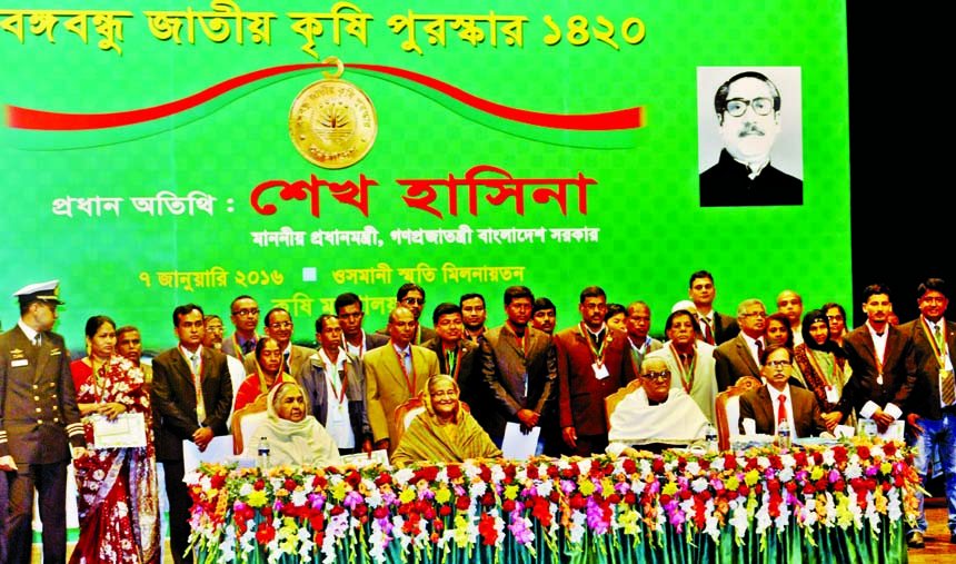 Prime Minister Sheikh Hasina poses for photograph with the recipients of Bangabandhu Jatiya Krishi Puroshkar and other guests at Osmani Memorial Auditorium in the city on Thursday. BSS photo