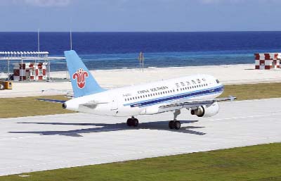 A China Southern Airlines jetliner lands at the airfield on Fiery Cross Reef, know as Yongshu Reef of the South China Sea.