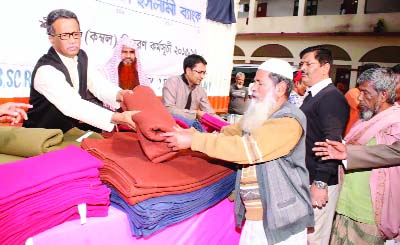 ARAIHAZAR(Narayanganj): Alhaj Fakir Akterruzzaman, MD, Shahjalal Islami Bank Ltd distributing blankets among the needy people at Paachrukhi Darul Hadis Salafia Madrasa in Araihazar Upazila as Chief Guest yesterday .
