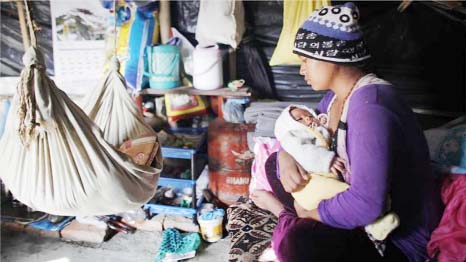 A Nepalese women protecting her child from severe cold at camp in Kathmandu.