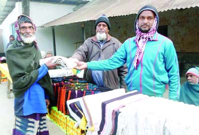 SAPAHAR (Naogaon): UP member and social worker Safiqul Islam(Chhoton) distributing blankets among the poor people of Shinint Union recently..