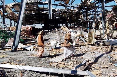 Yemeni workers inspect the damage at a factory after it was reportedly destroyed by Saudi-led airstrikes in the capital Sanaa.