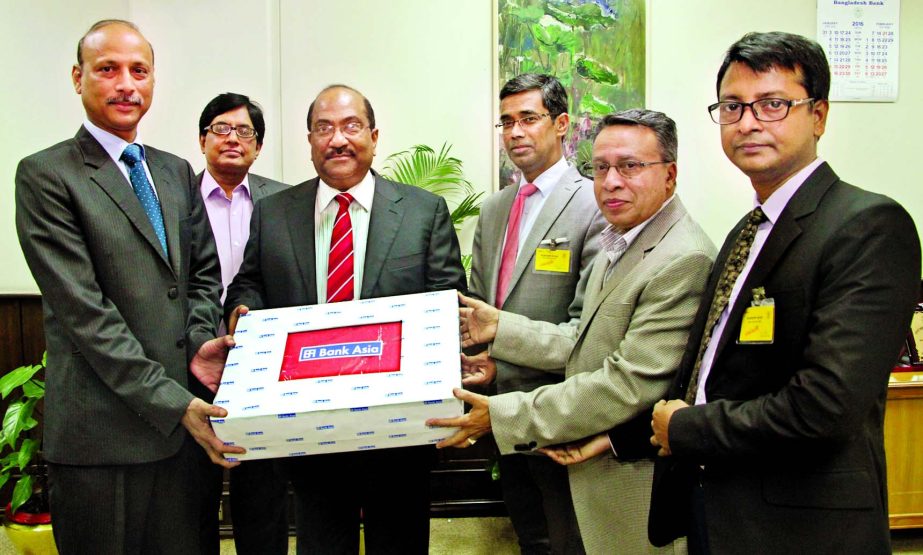 SK Sur Chowdhury, Deputy Governor of Bangladesh Bank receives a token of Bank Asia's contribution of blankets for cold-hit people from Md Arfan Ali, Additional Managing Director and MianQuamrulHasan Chowdhury, Deputy Managing Director of the bank at Bang