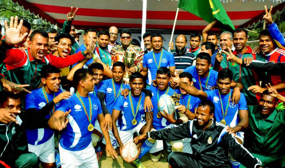 Members of Bangladesh Army, the champions of the Men's Division of the Walton National Rugby Competition and the guests and the officials of Bangladesh Rugby Federation pose for a photo session at the Paltan Maidan on Tuesday.