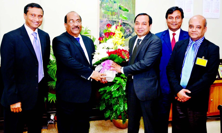 Managing Director of NRB Global Bank Proshanta Kumar Halder presenting a bouquet to SK Sur Chowdhury, Deputy Governor of Bangladesh Bank (BB) for being honored with Integrated Crop Management (ICM) Award -2016 for his outstanding contribution in banking