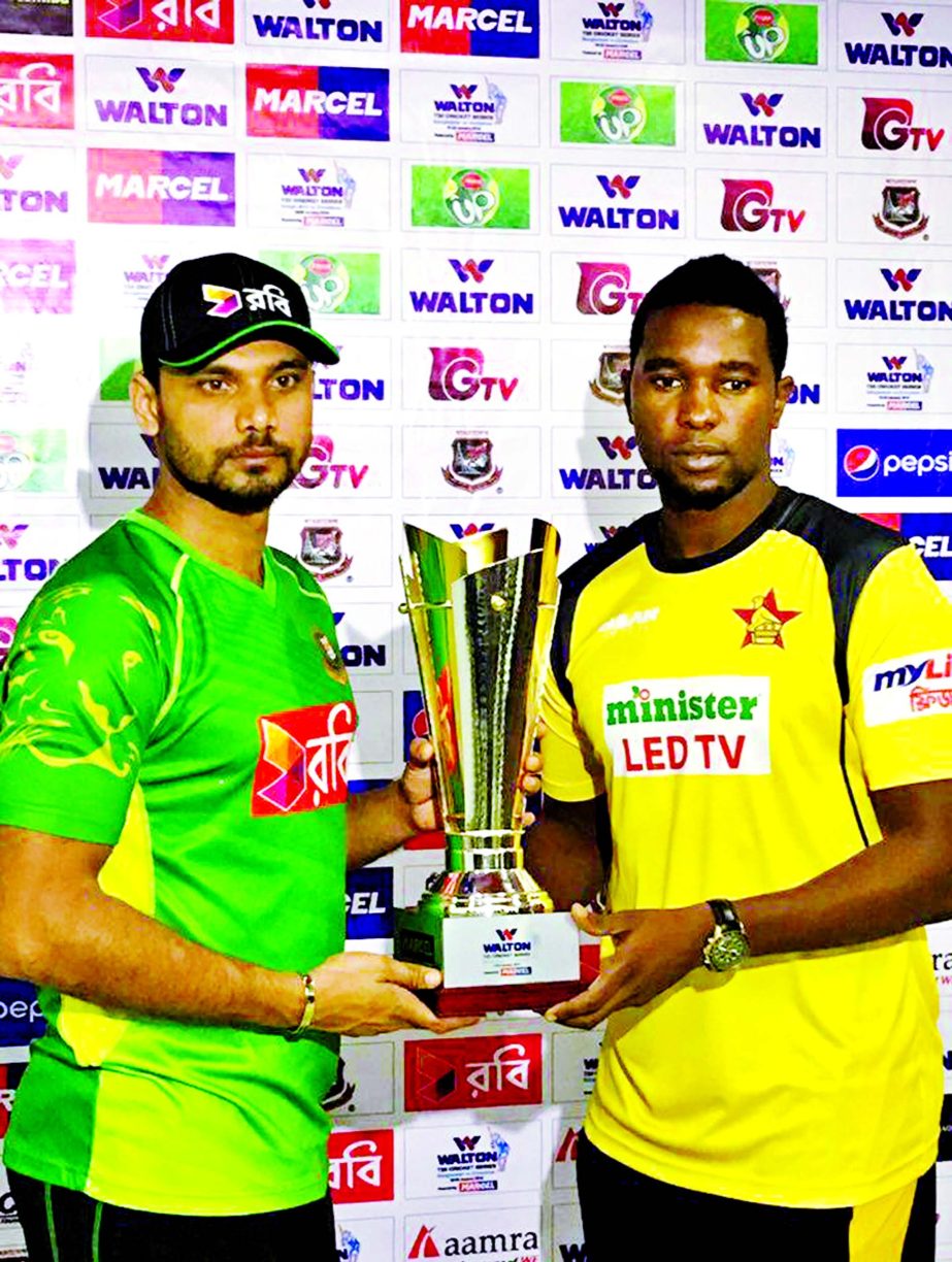 Captain of Bangladesh National Cricket team Mashrafe Bin Mortaza (left) and Captain of Zimbabwe National Cricket team Elton Chigumbura pose with the trophy of the four-match Walton T20 Cup at the Hotel City Inn in Khulna on Thursday.