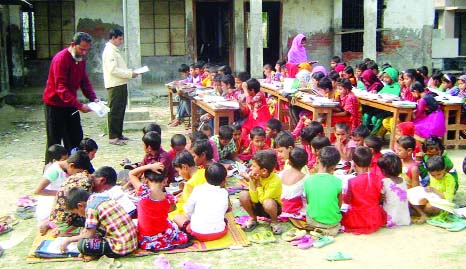 KHULNA: Students of Gazipur Govt Primary School at Terokhada in Khulna attending classes under open sky .