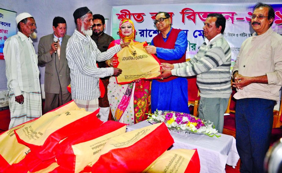 Civil Aviation and Tourism Minister Rashed Khan Menon distributing winter clothes among the destitute organized by Photojournalists Association at its auditorium in the city on Friday.