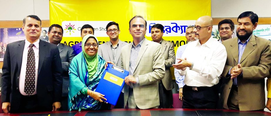 Grameen Shakti Managing Director Nurjahan Begum exchanging agreement documents with Sure Cash Chief Executive Officer Dr. Shahadat Khan in the city recently.