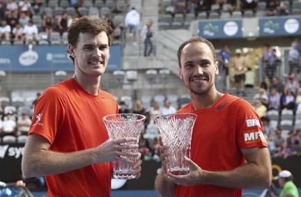 Jamie Murray of Britain (left) and Bruno Soares of Brazil hold their men's doubles trophies after defeating Rohan Bopanna of India and Florin Mergea of Romania in the final at the Sydney International Tennis tournament in Sydney, Australia on Saturday.