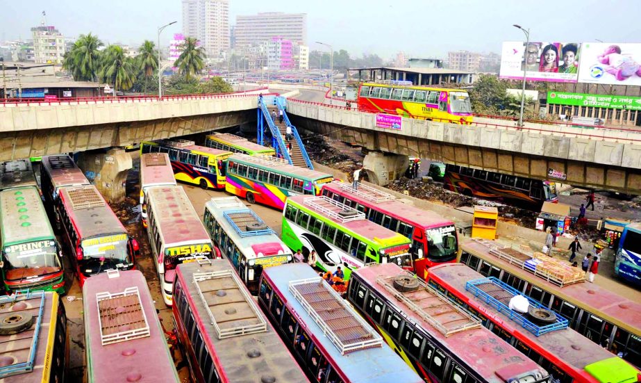 Several passenger buses plying under the Hanif Flyover to avoid toll causing sufferings to commuters. This photo was taken from Sayedabad area on Saturday.