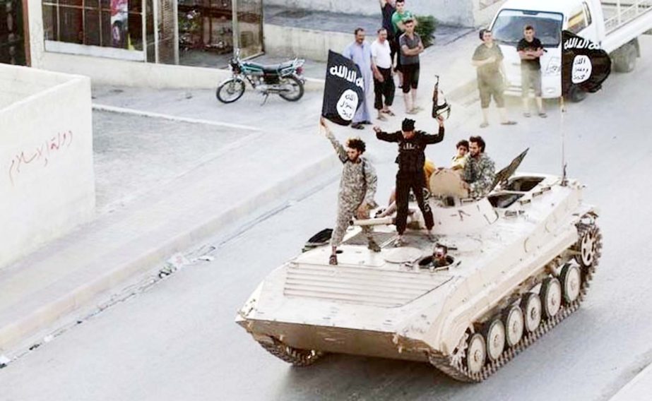 Islamic State militants parading at a city street in the eastern Syrian town of Deir Ezzor.