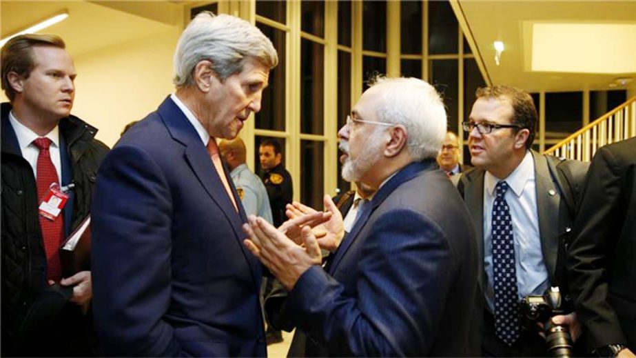 U.S. Secretary of State John Kerry talks with Iranian Foreign Minister Mohammad Javad Zarif, (right), after the International Atomic Energy Agency (IAEA) verified that Iran has met all conditions under the nuclear deal, in Vienna.