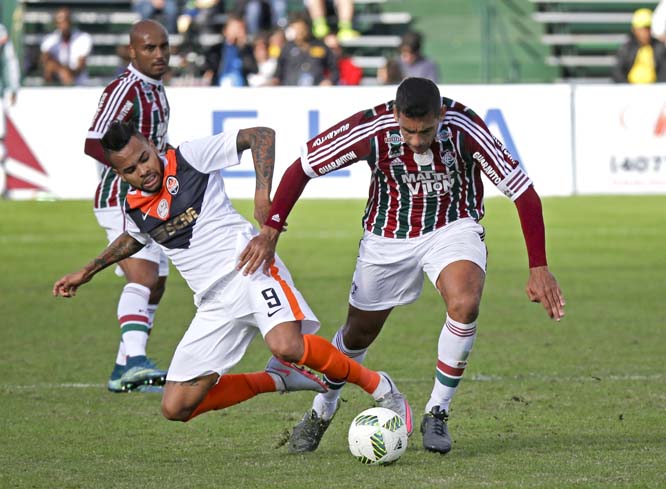 Shakhtar's Dentinho (9) goes down as he tries to keep the ball from Fluminense's Ronaldinho GaÃºcho (right) during the second half of a soccer match in the Florida Cup in Kissimmee, Fla on Sunday. The game ended in a 1-1 draw.