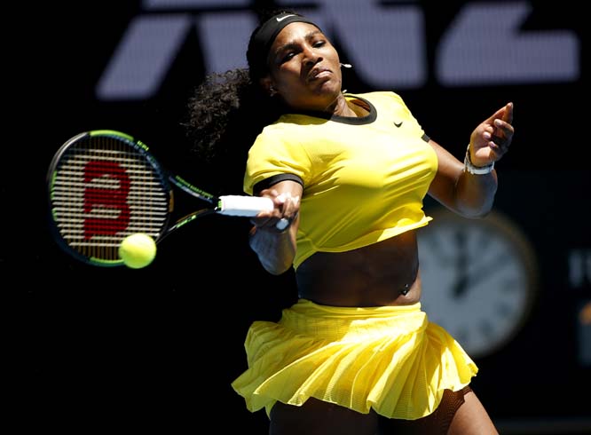 Serena Williams of the United States makes a forehand return to Camila Giorgi of Italy during their first round match at the Australian Open tennis championships in Melbourne, Australia on Monday