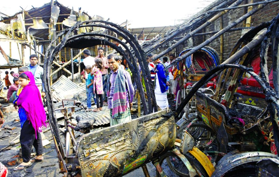 Several slum houses, rickshaw van and shops were gutted in a fire that broke out at Rayer Bazar area in city on Monday.