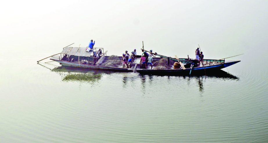 MYMENSINGH: Illegal sand lifting continues beside Altaf Hossain Golondaj Bridge at Gafargaon Upazila. This picture was taken on Tuesday.