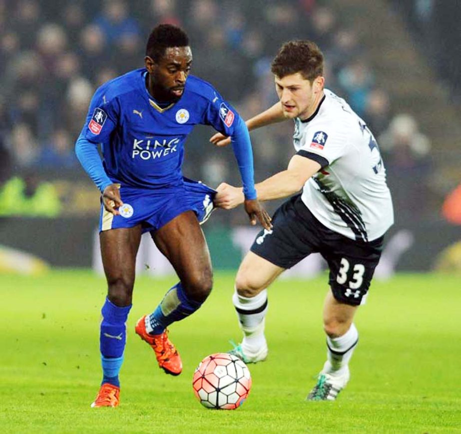 Leicesterâ€™s Nathan Dyer, left, is held back by Tottenhamâ€™s Ben Davies during the English FA Cup third round soccer match between Leicester City and Tottenham Hotspur at the King Power Stadium in Leicester, England on Wednesday.