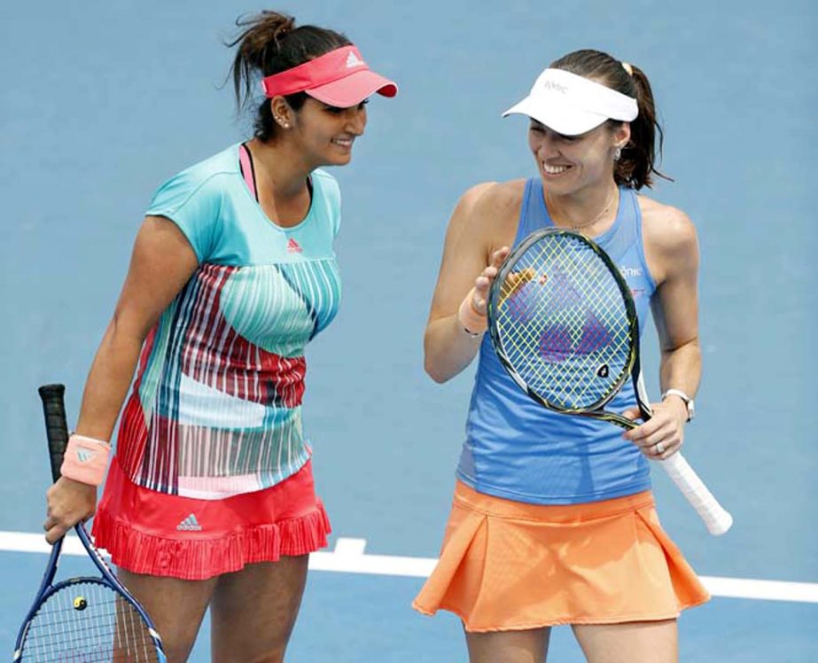 Switzerland's Martina Hingis (right) and India's Sania Mirza chat during their first round match against Brazil's Teliana Pereira and Colombia's Mariana Duque-Marino at the Australian Open tennis championships in Melbourne, Australia on Thursday