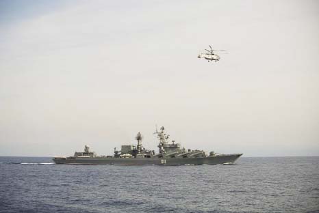 A Russian navy helicopter flies over the Russian missile cruiser Varyag on patrol in eastern Mediterranean on Thursday.