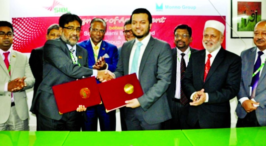 Tarik Morshed, Deputy Managing Director of Social Islami Bank Limited (SIBL) exchanging agreement documents with Rasheed Mymunul Islam, Deputy Managing Director of Monno Group of Industries in the city on Thursday.